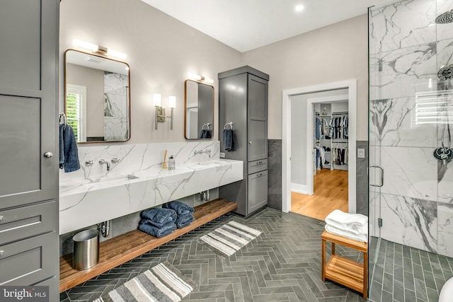 bathroom with an enclosed shower, dual vanity, tasteful backsplash, and hardwood / wood-style floors