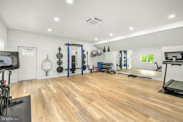 workout room with light hardwood / wood-style flooring