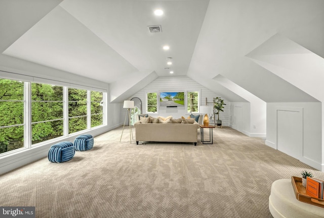 bedroom featuring light carpet and lofted ceiling