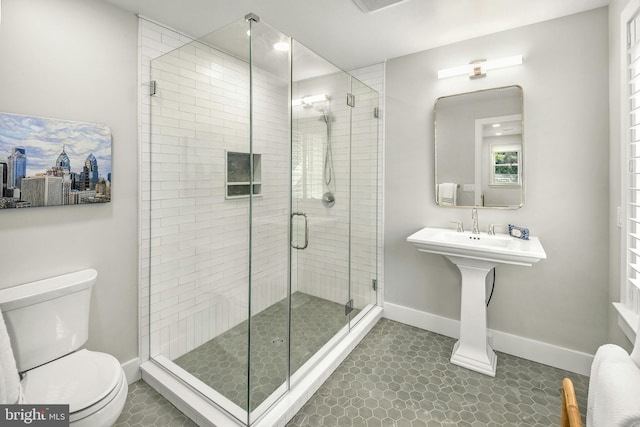 bathroom with tile floors, an enclosed shower, and toilet