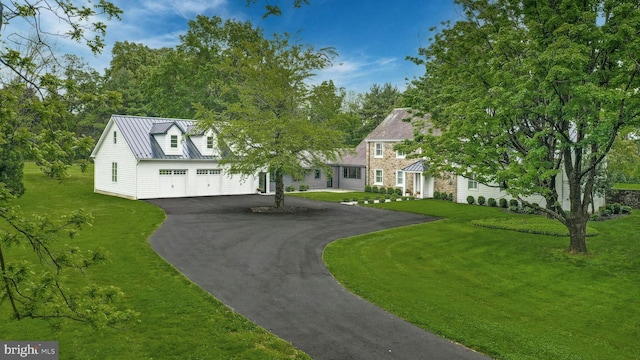 view of front of house featuring a garage and a front lawn