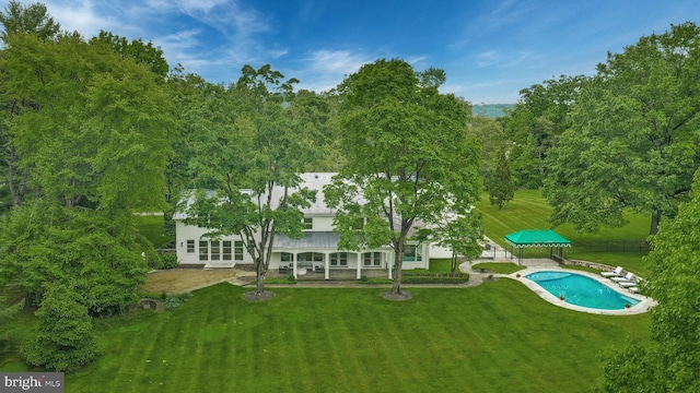 back of house featuring a gazebo and a lawn