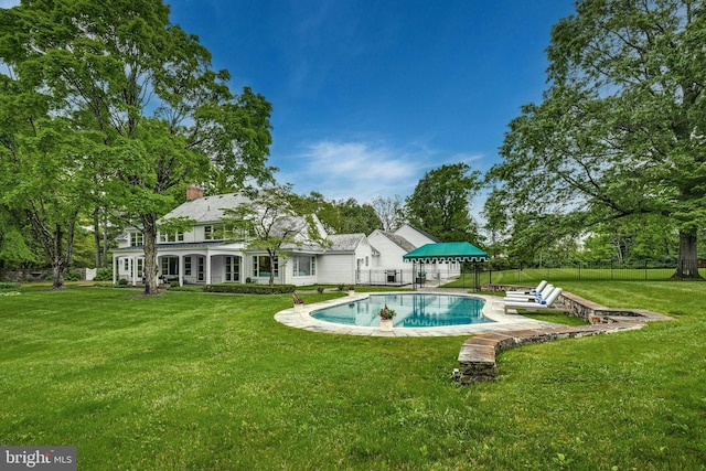 exterior space with a yard, a fenced in pool, and a patio