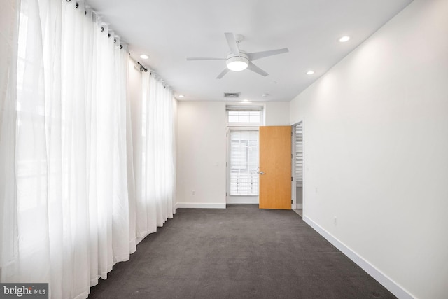 carpeted empty room featuring ceiling fan