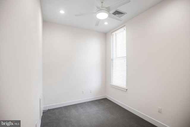 carpeted spare room with ceiling fan