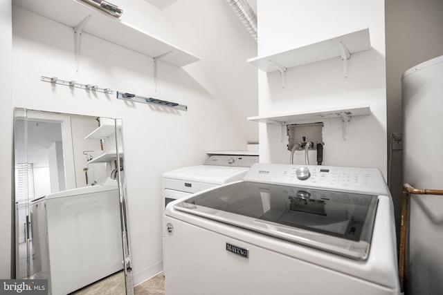 clothes washing area featuring independent washer and dryer