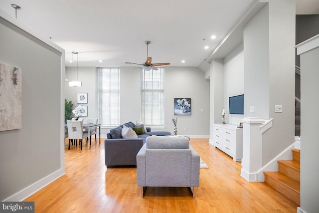 living room featuring light wood-type flooring and ceiling fan