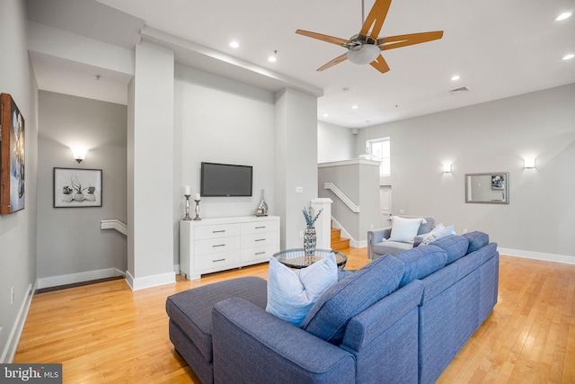 living room featuring ceiling fan and light wood-type flooring