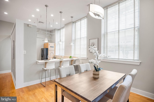 dining space featuring plenty of natural light and light wood-type flooring