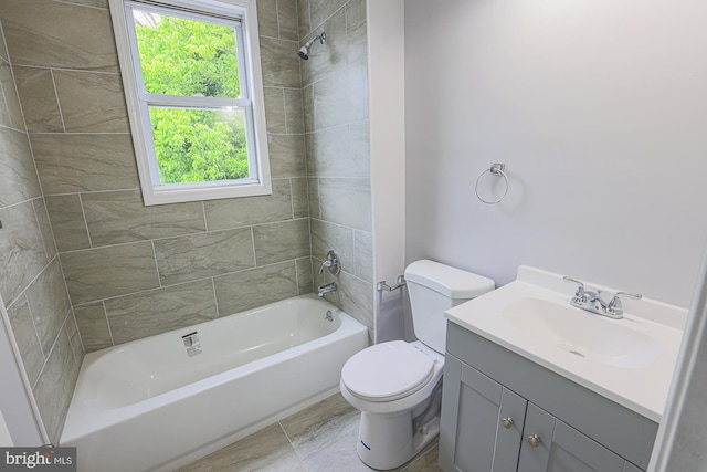 full bathroom featuring vanity, toilet, and tiled shower / bath combo