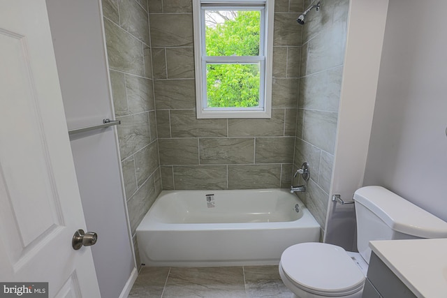 full bathroom featuring tile patterned floors, vanity, toilet, and tiled shower / bath combo