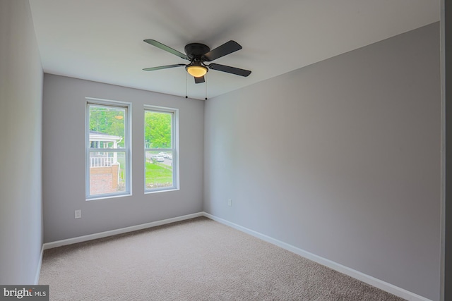 unfurnished room featuring ceiling fan and carpet floors