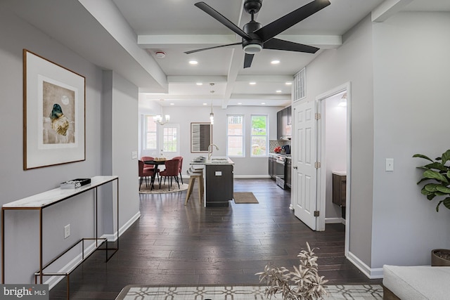 interior space featuring beam ceiling, dark hardwood / wood-style floors, an inviting chandelier, and sink