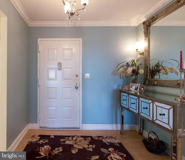 entryway with a chandelier, hardwood / wood-style flooring, and crown molding