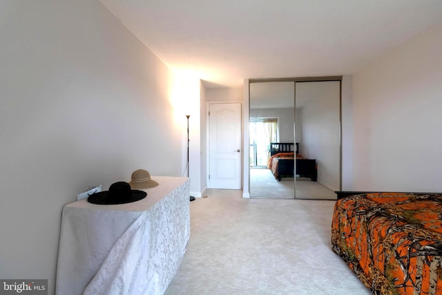 bedroom with light carpet and a closet