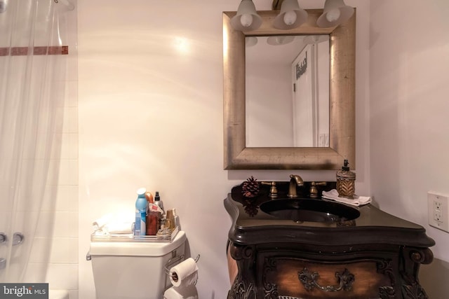 bathroom featuring toilet and vanity