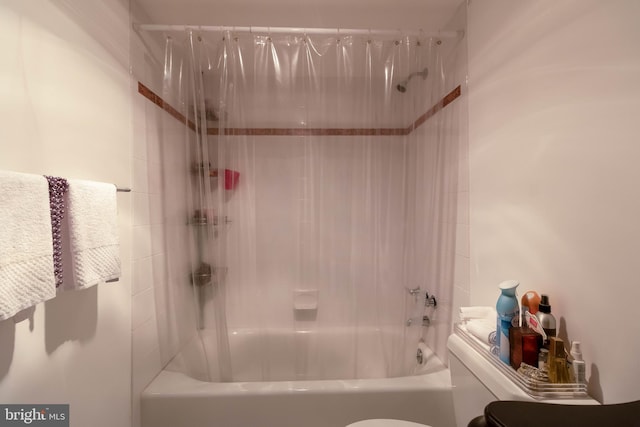 bathroom featuring shower / bath combination and toilet