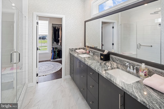 bathroom featuring double vanity, walk in shower, and tile flooring