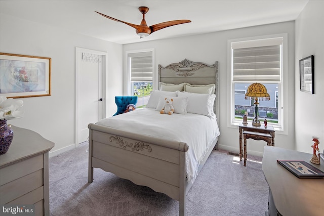 bedroom featuring light carpet and ceiling fan