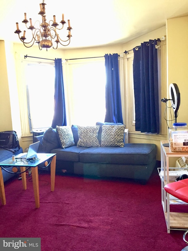 living room with carpet flooring and an inviting chandelier