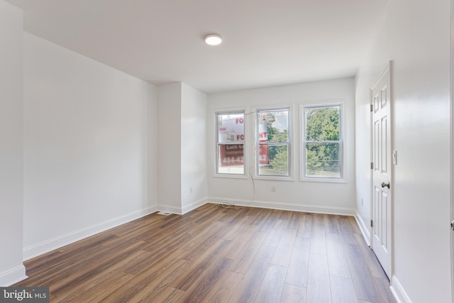 empty room with dark hardwood / wood-style floors