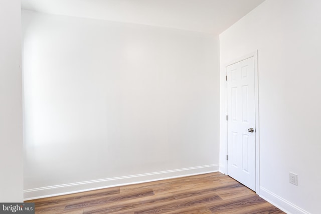 empty room with hardwood / wood-style flooring