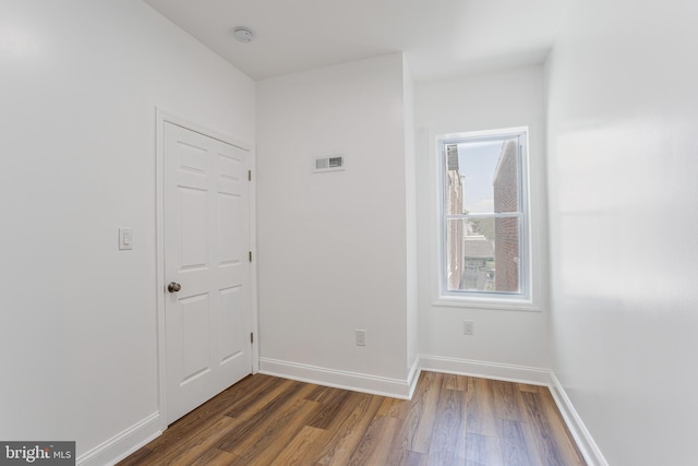 unfurnished room featuring dark wood-type flooring