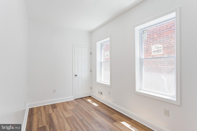 unfurnished room with hardwood / wood-style flooring