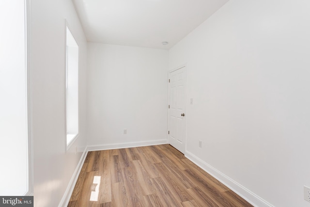 empty room with hardwood / wood-style floors