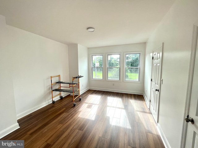 spare room featuring dark wood-type flooring