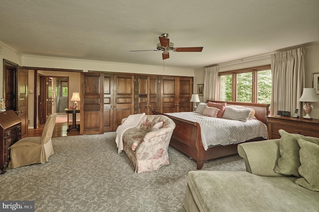 bedroom with ornamental molding, carpet floors, and ceiling fan