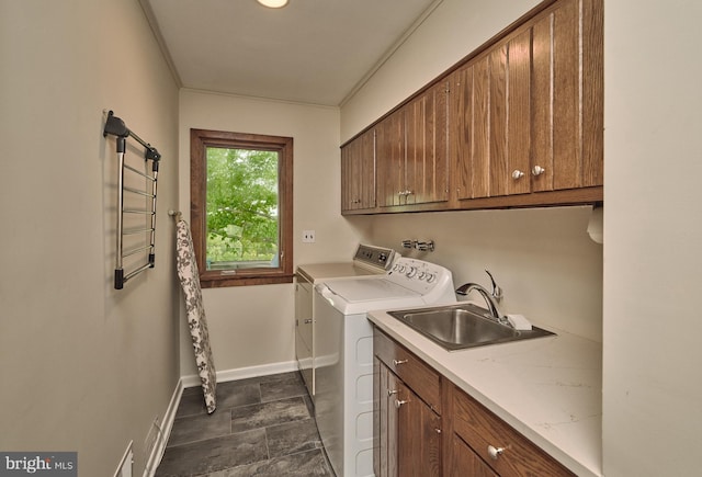 clothes washing area featuring independent washer and dryer, cabinets, dark tile flooring, washer hookup, and sink