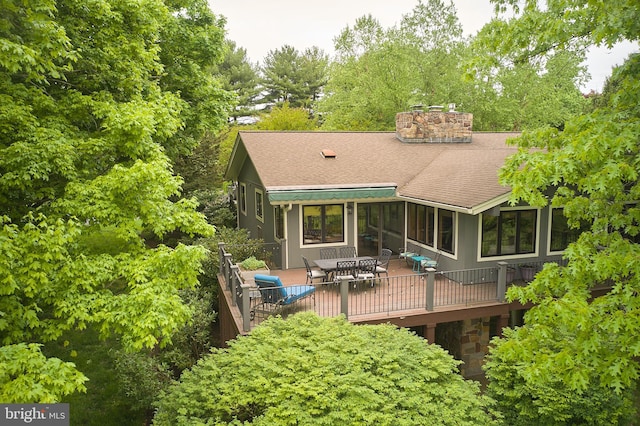 rear view of property featuring a deck