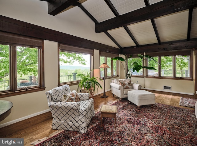 living room featuring lofted ceiling with beams and wood-type flooring