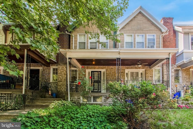 rear view of property with ceiling fan