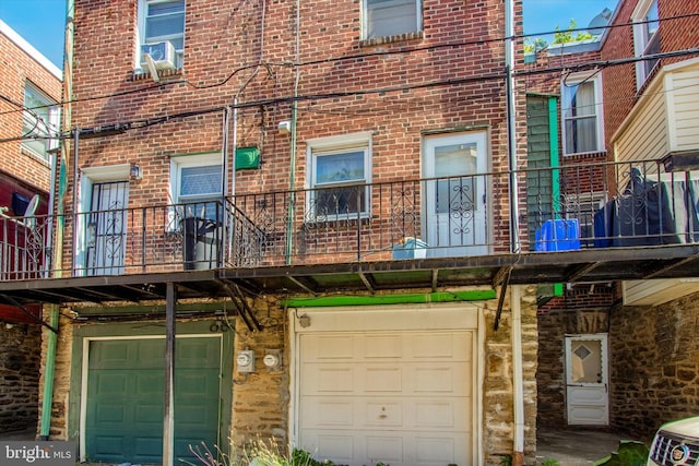 exterior space with a balcony and a garage