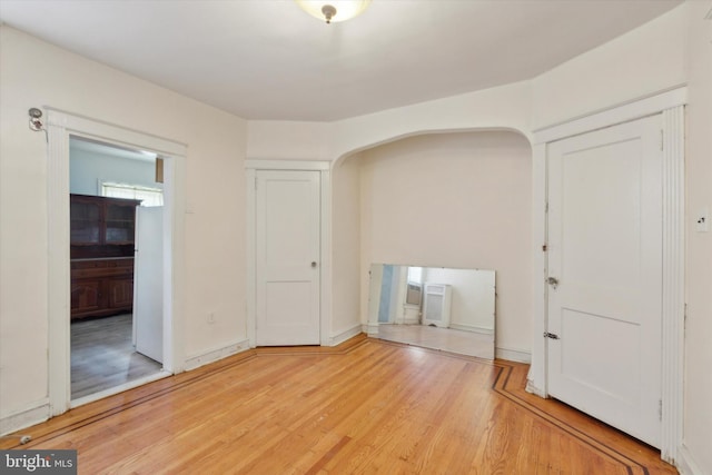 spare room with wood-type flooring