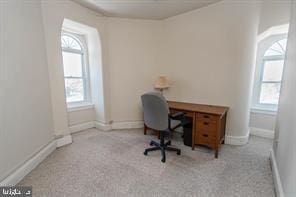 home office featuring plenty of natural light and light colored carpet