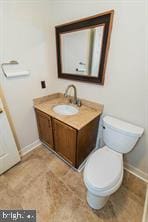 bathroom with toilet and vanity