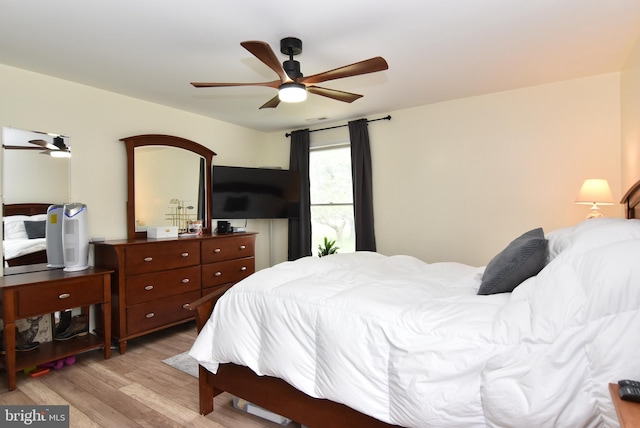 bedroom with light wood-type flooring and ceiling fan