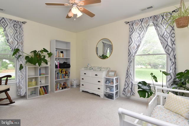 sitting room with carpet floors, a wealth of natural light, and ceiling fan