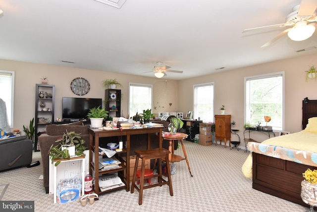 bedroom with light carpet and ceiling fan