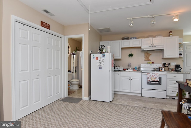 kitchen featuring white cabinetry, sink, rail lighting, white appliances, and light carpet