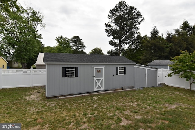 view of outbuilding featuring a yard