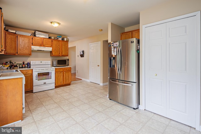 kitchen with sink, light tile floors, and stainless steel appliances