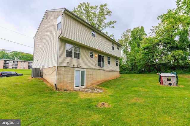 back of house featuring a yard and central air condition unit