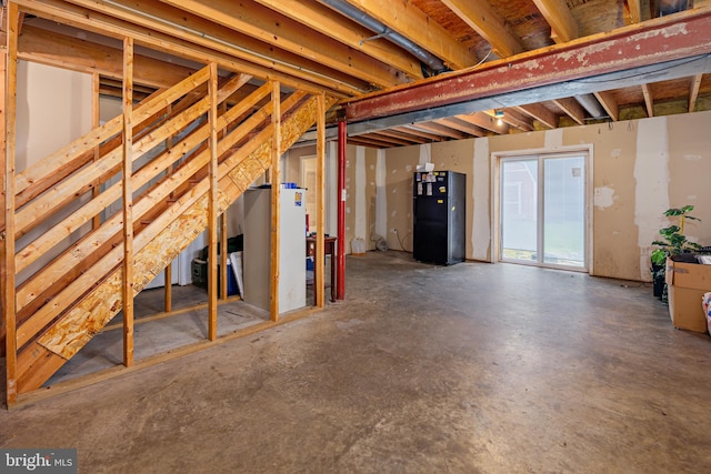 basement with black fridge