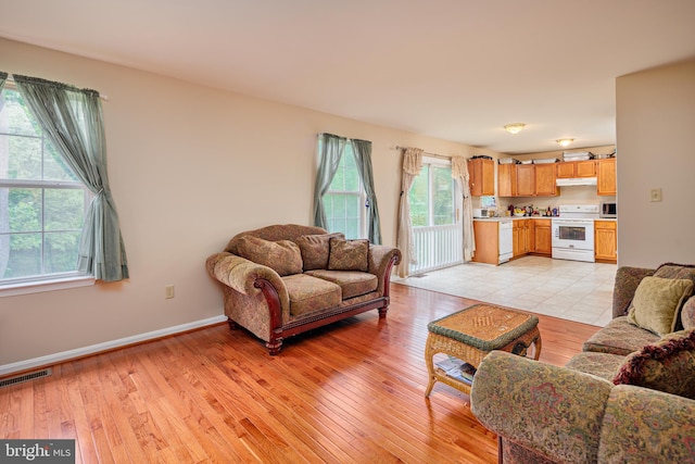 tiled living room with a healthy amount of sunlight