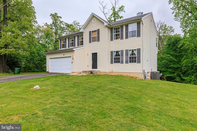 colonial inspired home with a garage, a front yard, and central air condition unit