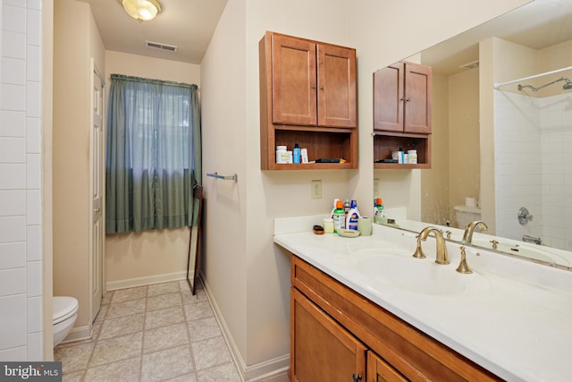 bathroom with oversized vanity, toilet, and tile floors